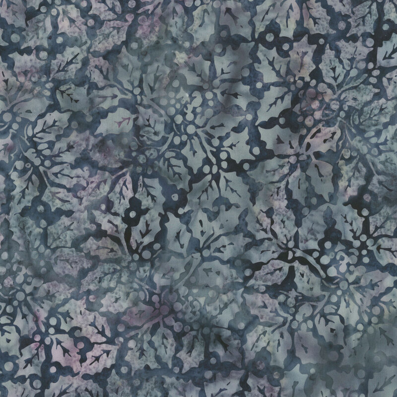 gray holly leaves and berries tossed on a mottled dark blue gray and mauve background.