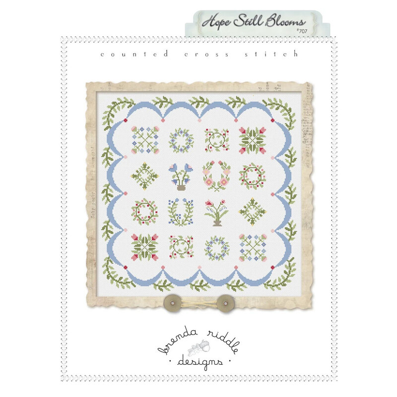 Front of Hope Still Blooms cross stitch pattern featuring the finished floral project framed.