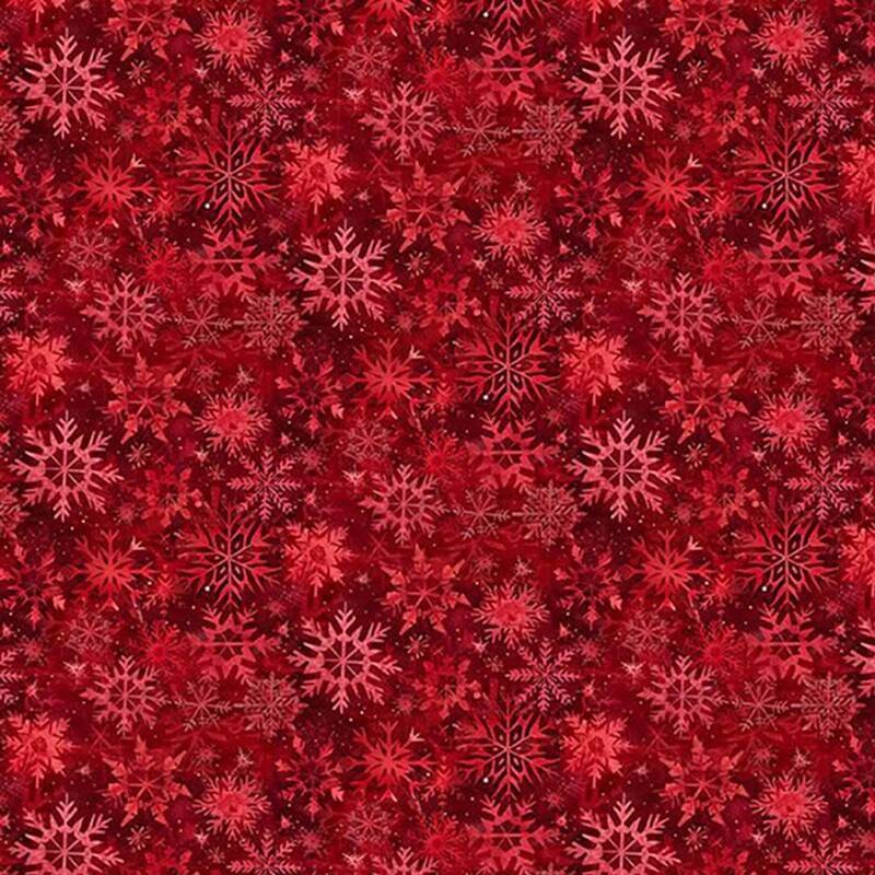 Red fabric with a packed design of snowflakes.