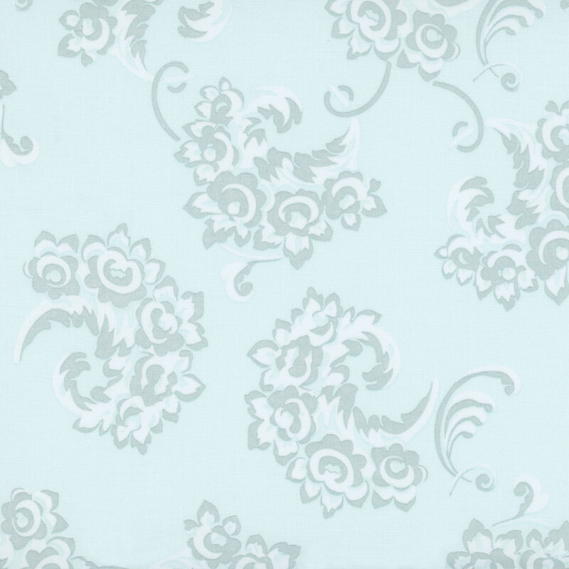 stylized floral bouquets in shades of pale aqua and icey white on a bleached denim background.