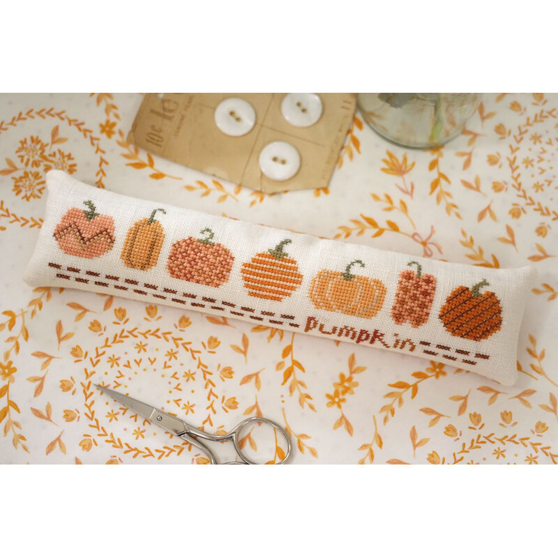 The front of the pattern, showing the finished project displayed on an autumally-themed tabletop.