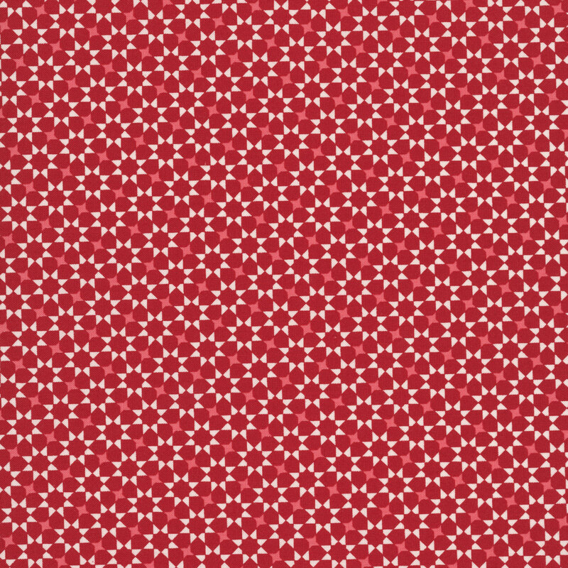 repeating white and pink geometric star pattern on a red fabric.