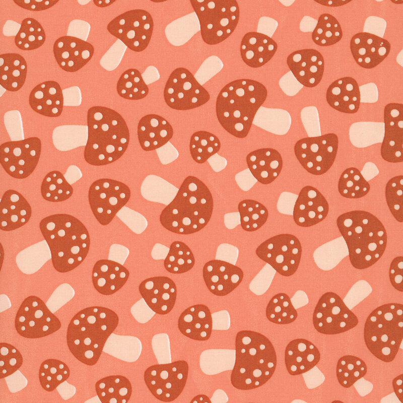 This coral orange fabric features scattered terra cotta mushrooms.