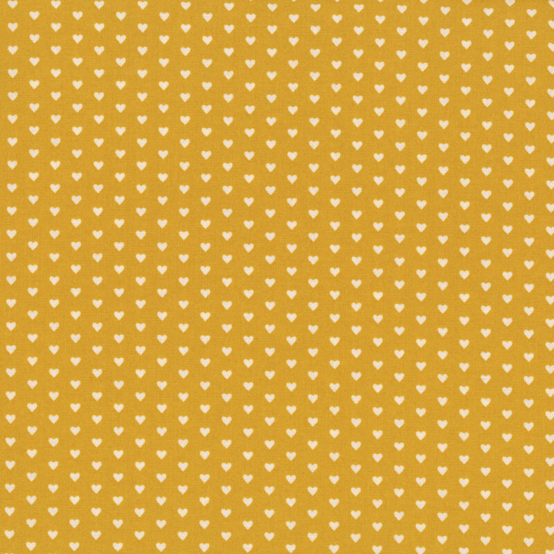 This ocher fabric features rows of tiny cream hearts. 