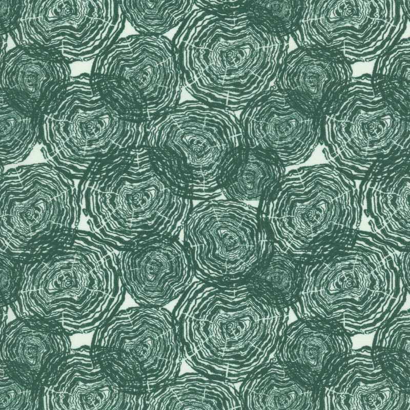 Light aqua fabric with tossed teal tree rings.