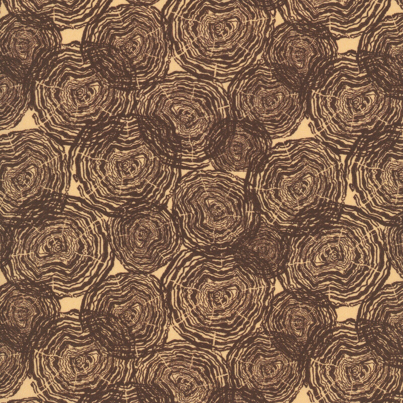 Cream fabric with tossed brown tree rings.