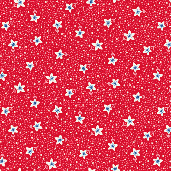 A red fabric with white flowers, stars, and pink scattered dots.