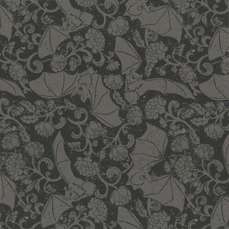 Black fabric with a tossed pattern of soft black bats and swirling vines with florals.