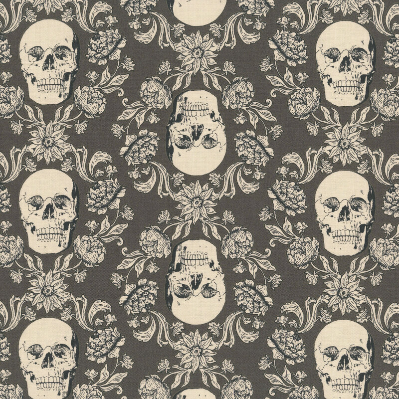 Charcoal fabric with a cream-colored ornamental design of floral vines surrounding skulls.