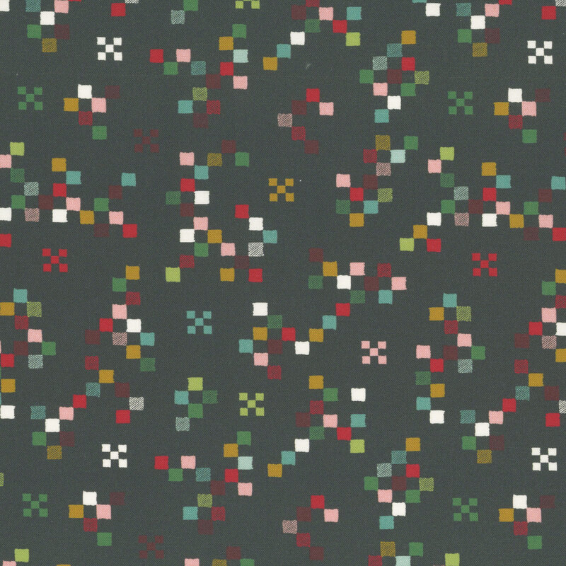 Soft black fabric with a scattered geometric design of squares in a medley of Christmastime colors.