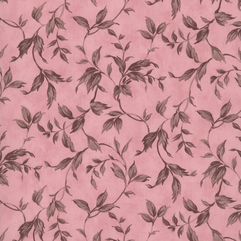 Pink fabric with a swirling pattern of vines and leaves.