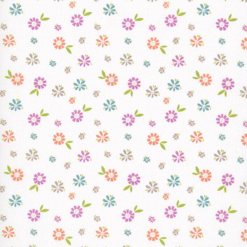 A white fabric with colorful, scattered florals and leafy sprigs.