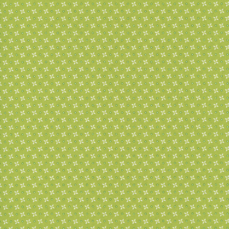 A lime green fabric with rows of circles and four-petal flower motifs.