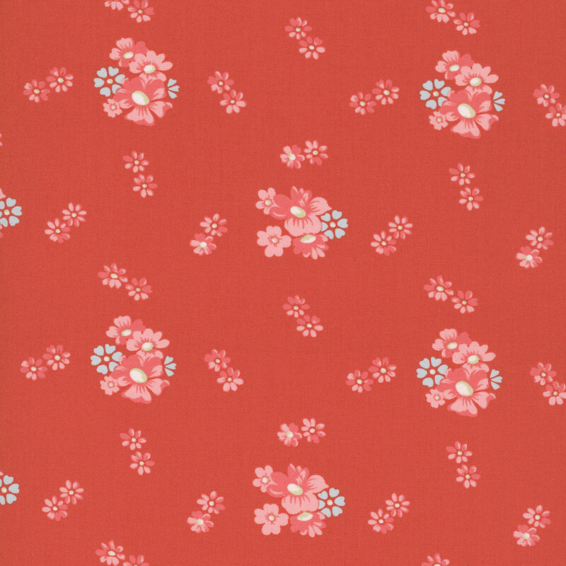clusters of pink and pale blue floral blossoms scattered on a tomato red background.