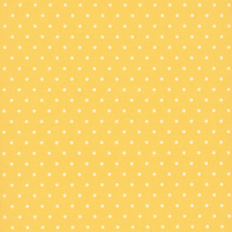 white polka dots on a sunshine yellow background.
