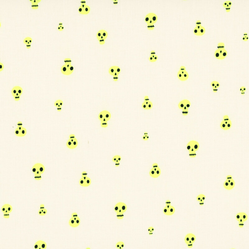A cream fabric with scattered neon yellow skulls.