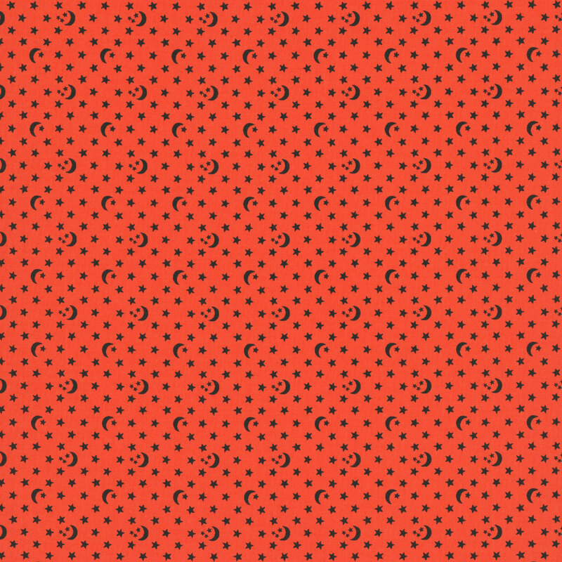 A coral orange fabric with scattered stars and crescent moons.