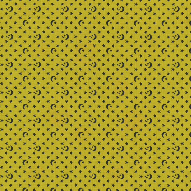 An olive green fabric with scattered black stars and crescent moons.