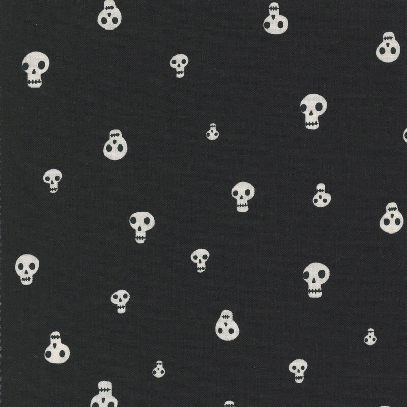 A black fabric with scattered white skulls.