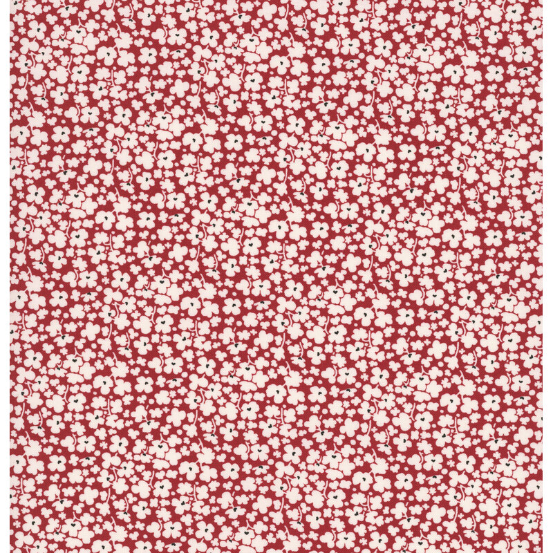 Red fabric with a dense pattern of white florals.