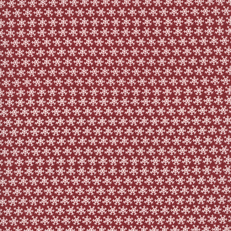 Red fabric with a dense pattern of white snowflakes.
