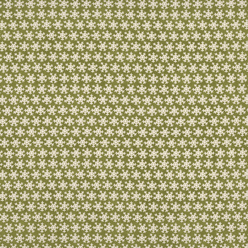 Green fabric with a dense pattern of white snowflakes.