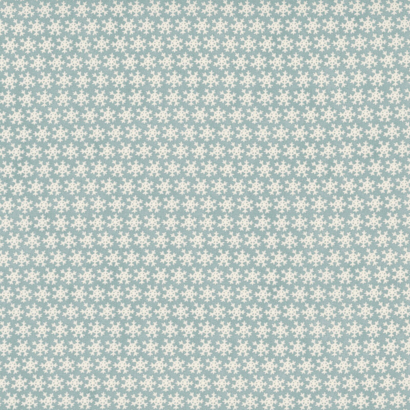 Soft blue fabric features a dense pattern of white snowflakes.