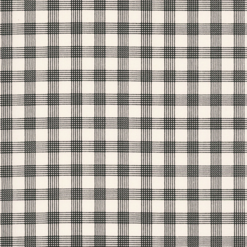 Cream fabric with a classic black gingham pattern. 