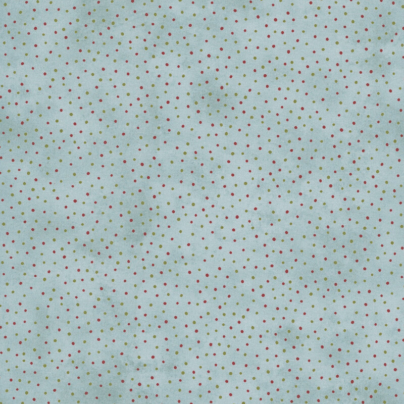 Mottled blue fabric with a pattern of scattered red and green dots.