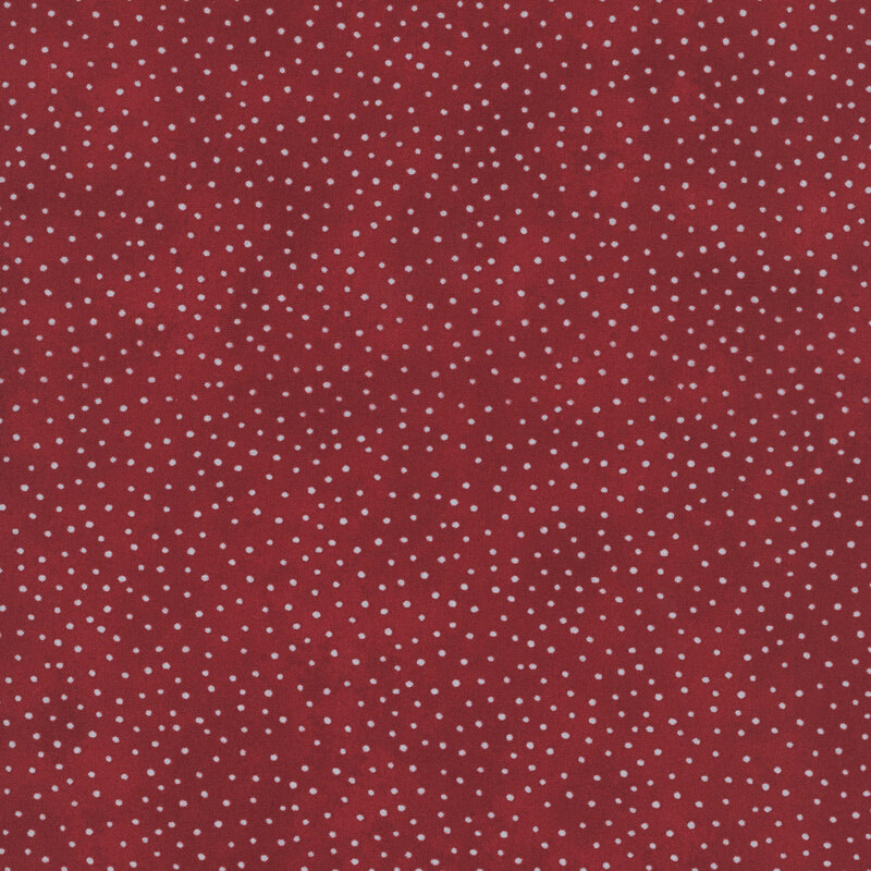 Mottled red fabric with a pattern of scattered white dots.