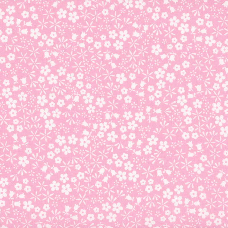 Bubblegum pink fabric with a scattered pattern of white floral blooms.