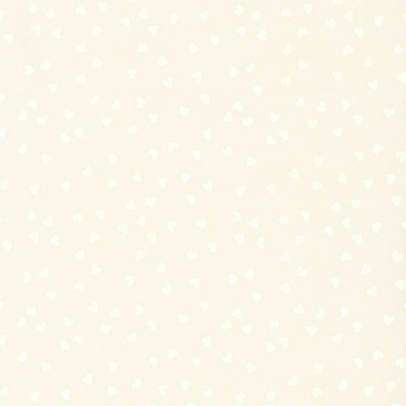 Tonal cream fabric with a playful tossed pattern of small white hearts.