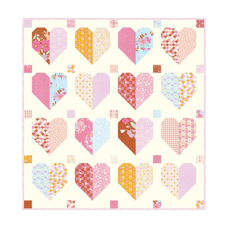 Digital mockup of the finished Fluttered Hearts quilt pattern with a medley of patchwork hearts and squares on a cream fabric.