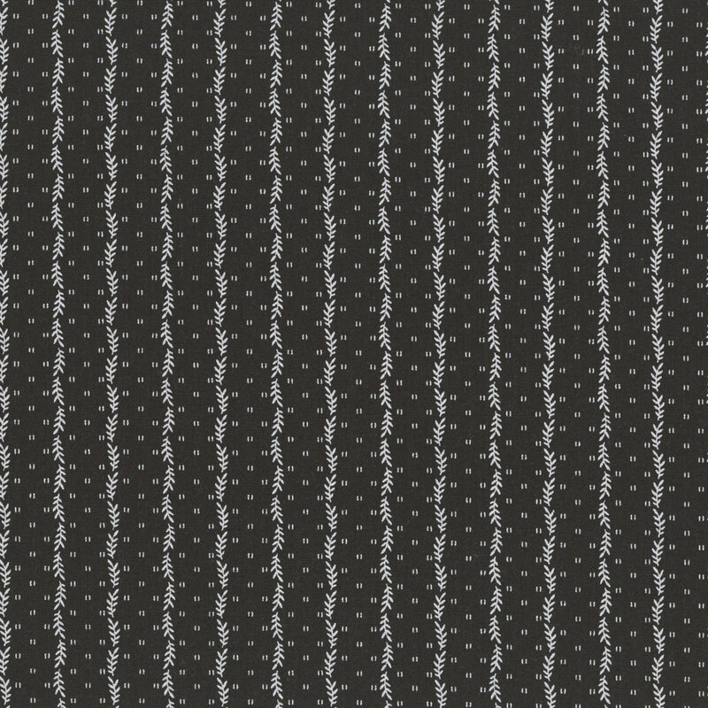 Charcoal black fabric with a striped pattern of small white leaves decorated with small, scattered primitive markings.