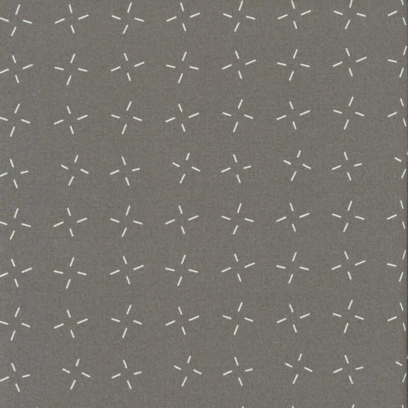 Ash gray fabric with an abstract design of white dashes grouped together.