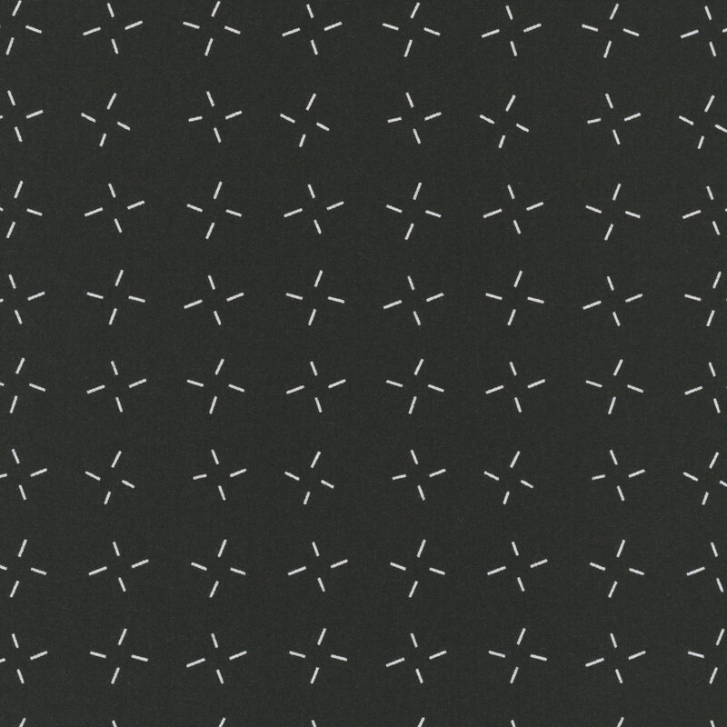 Black fabric with an abstract design of white dashes grouped together.
