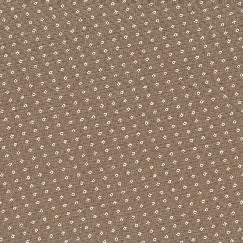 Chocolate colored fabric with a biased grid design of small white squares.