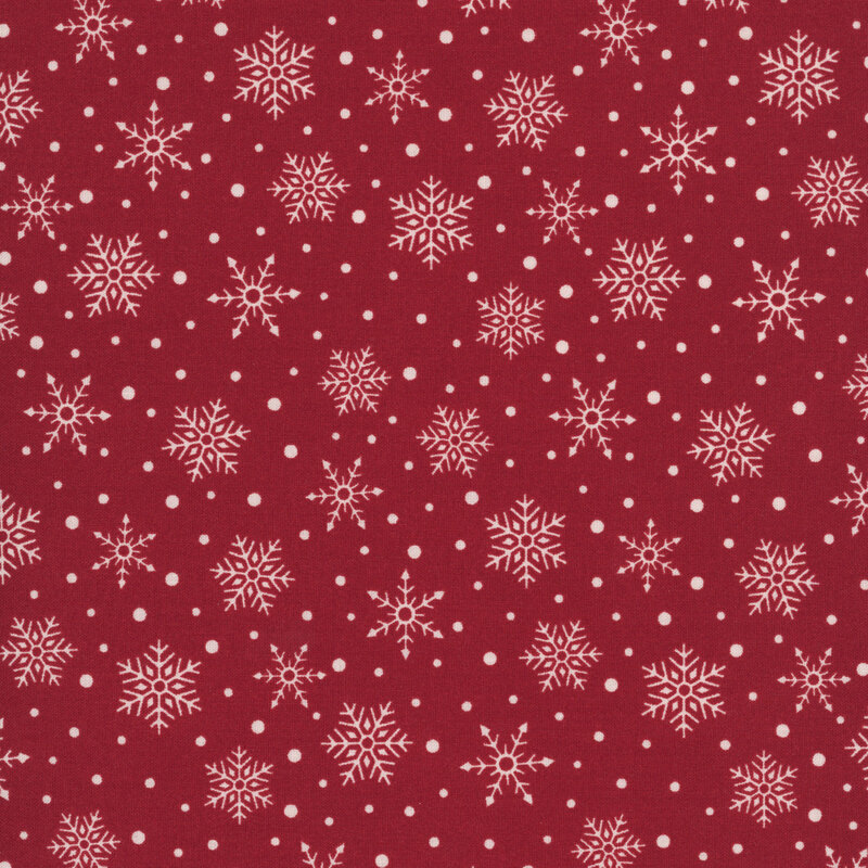 Red fabric with a scattered pattern of white snowflakes and dots.