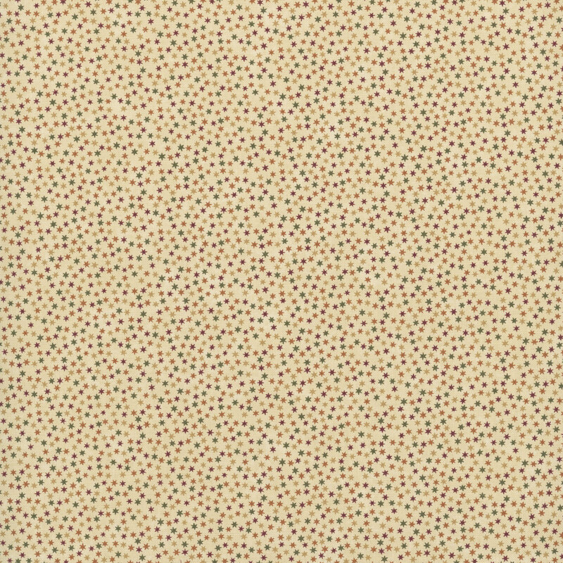sand fabric packed with scattered stars in hues of gold, tan, green, and burgundy