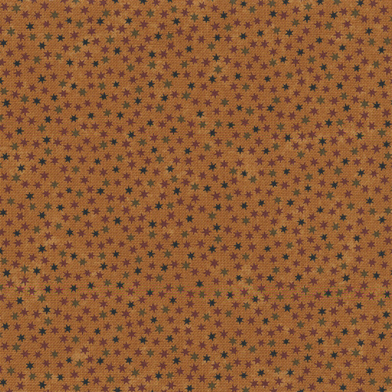mottled dark gold fabric packed with scattered stars in hues of burgundy, green, and black