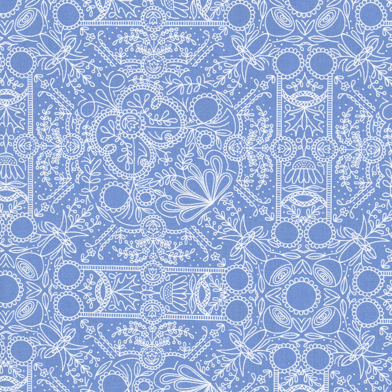 A light blue fabric with intricate blue linework forming symmetrical folk-art flowers, leafy vines, scrolls, and ornamental medallions.