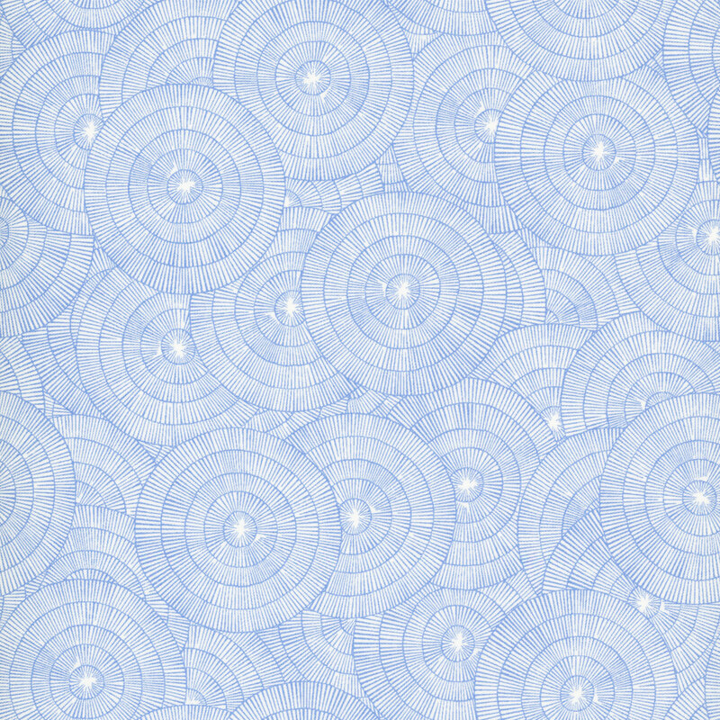 A white fabric with overlapping blue concentric circles made of fine radiating lines.