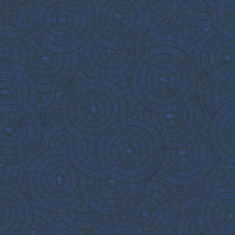 An indigo blue fabric with overlapping blue concentric circles made of fine radiating lines.