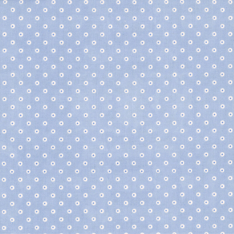 A powder blue fabric with white polka dots and blue centers.