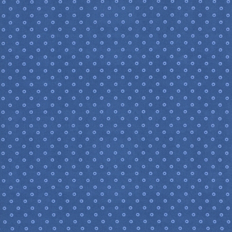 A blue fabric with hollow light blue polka dots.
