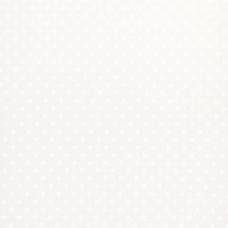 A white fabric with hollow white polka dots.