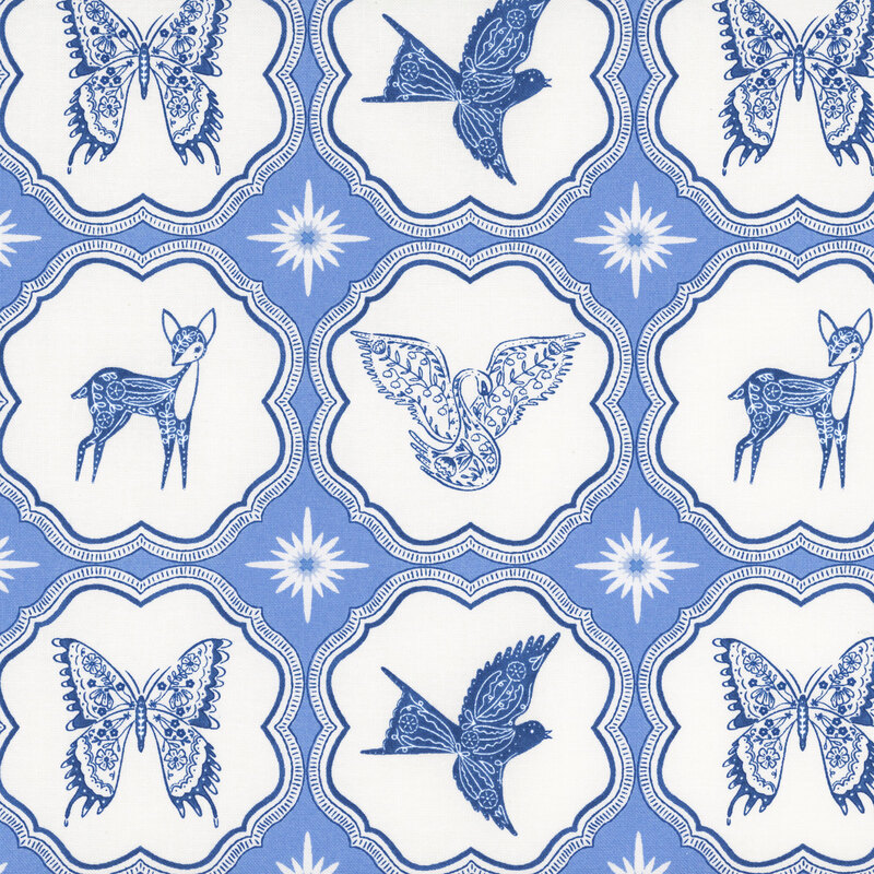 A powder blue fabric with blue butterflies, birds, and deer inside scalloped ornamental frames separated by white starbursts.