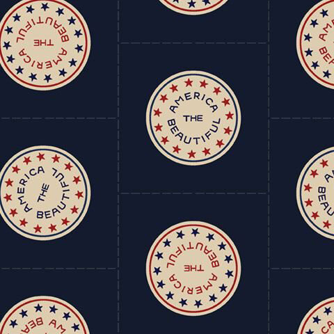 Navy blue fabric with a half-drop design of circular sticker motifs with rings of stars and the phrase "America The Beautiful".