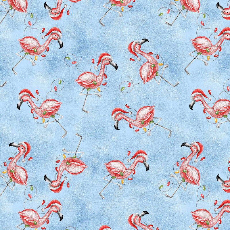 A light blue fabric with scattered pink flamingos wearing Santa hats and wrapped in colorful Christmas lights.
