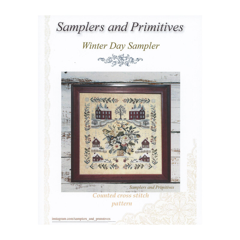 Front cover of the Winter Day Sampler showing the finished pattern in a wooden frame isolated on a quaint wooden background.